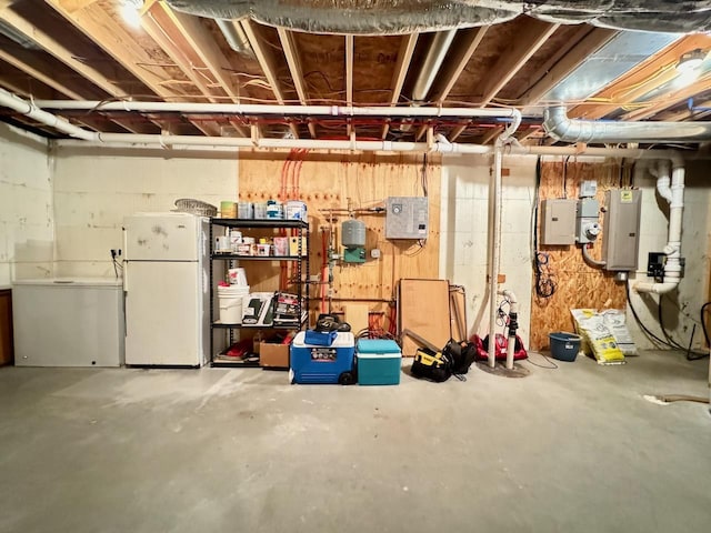 basement with white fridge and electric panel