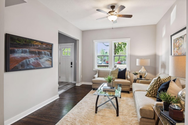 living room with ceiling fan and dark hardwood / wood-style flooring