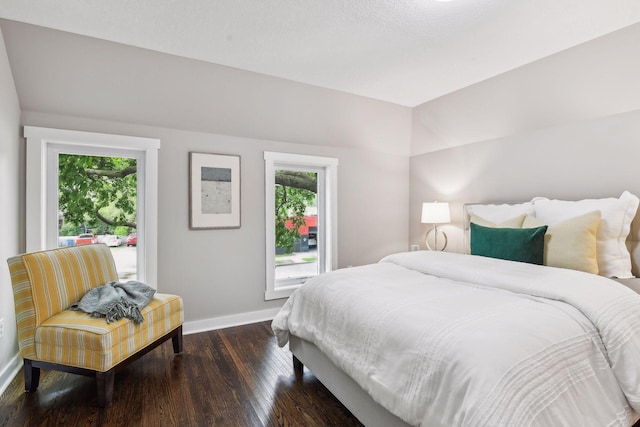 bedroom with dark hardwood / wood-style flooring