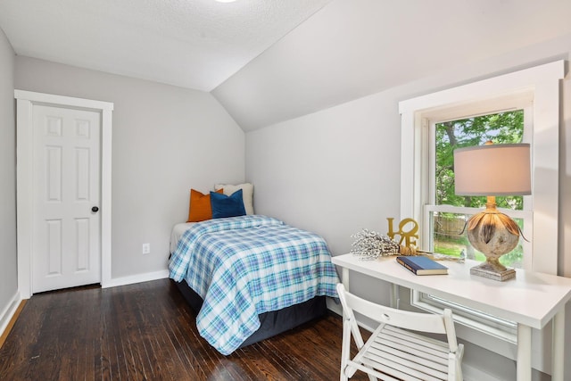 bedroom featuring dark hardwood / wood-style floors and vaulted ceiling