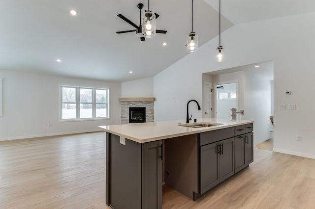 kitchen featuring light countertops, a sink, and light wood-style flooring