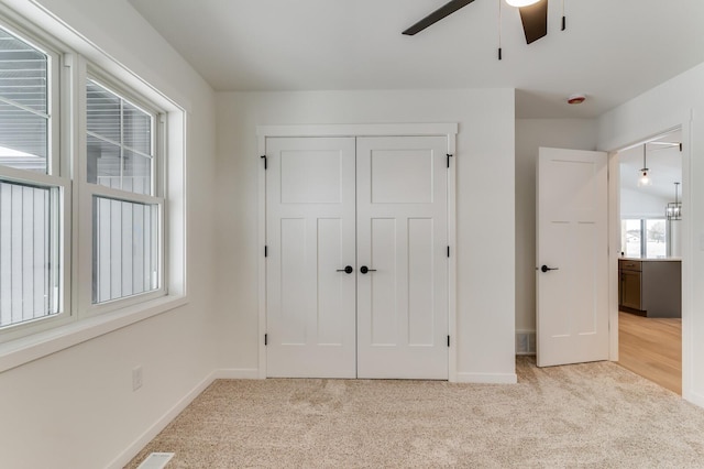 unfurnished bedroom featuring carpet floors, a closet, and baseboards