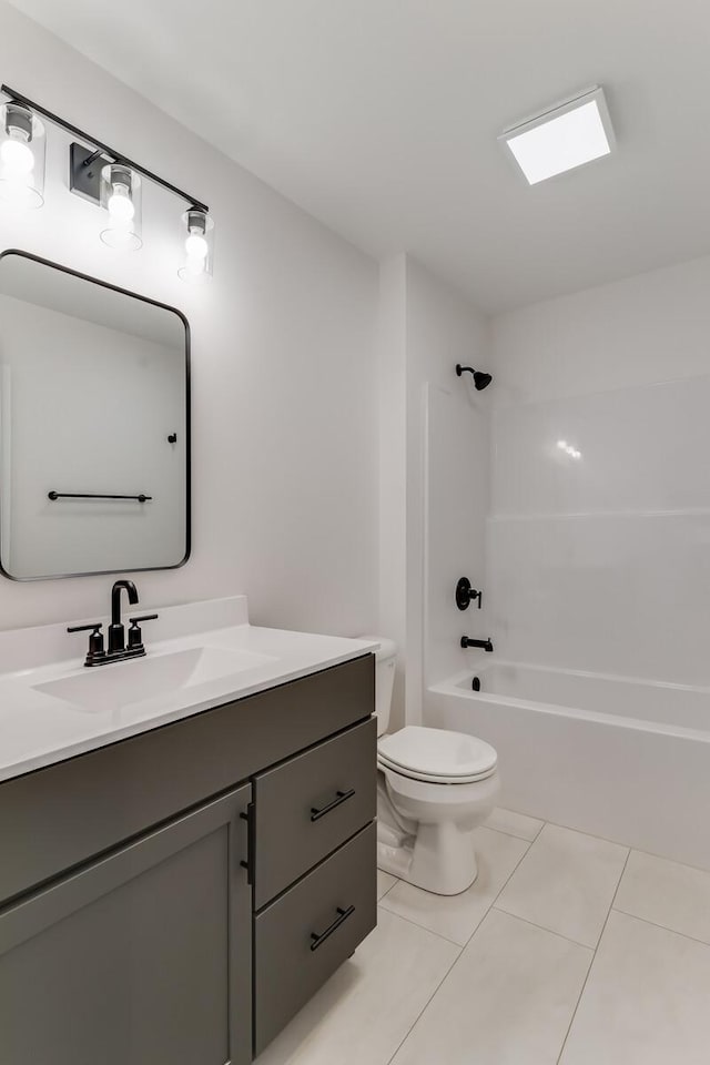 full bathroom with tile patterned flooring, tub / shower combination, vanity, and toilet