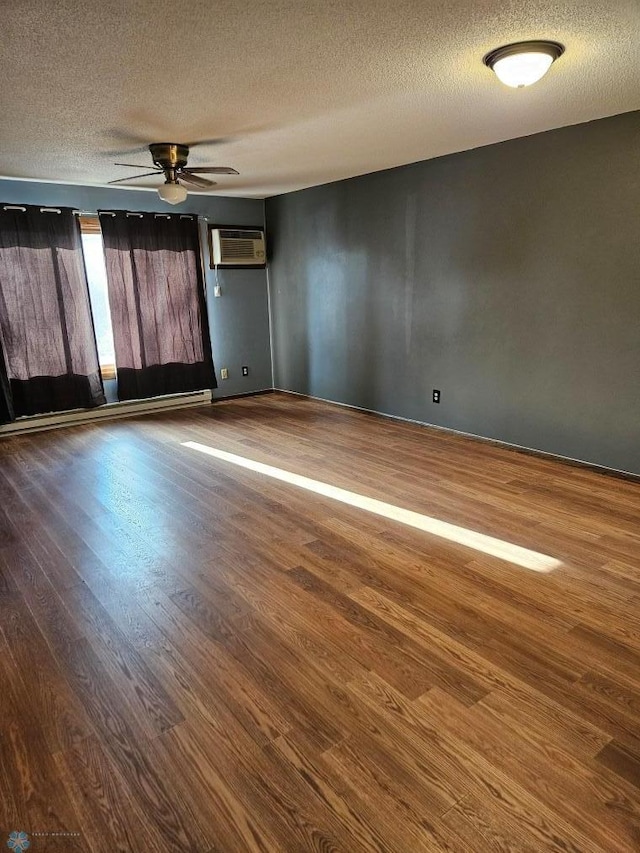 unfurnished room featuring hardwood / wood-style flooring, ceiling fan, an AC wall unit, and a textured ceiling