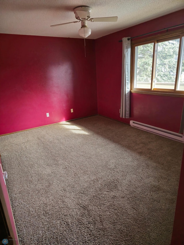 unfurnished room with a baseboard heating unit, a ceiling fan, carpet floors, and a textured ceiling