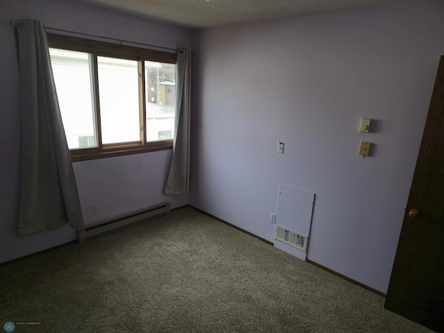 carpeted spare room with a baseboard radiator, baseboards, and a textured ceiling