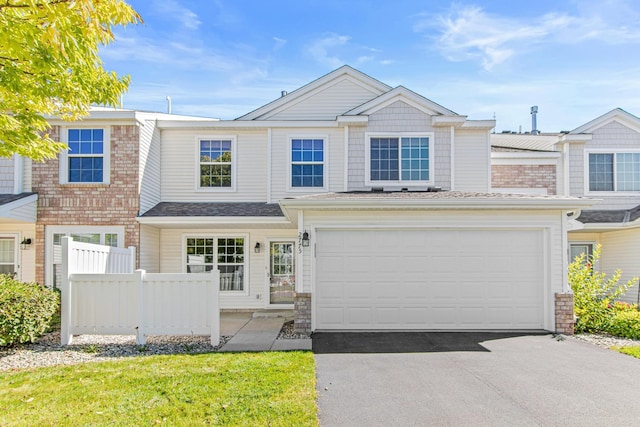 multi unit property featuring a front yard and a garage