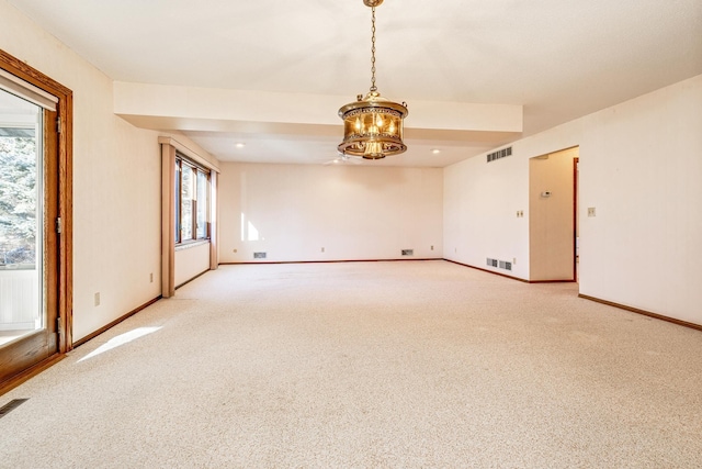 spare room with an inviting chandelier and carpet flooring