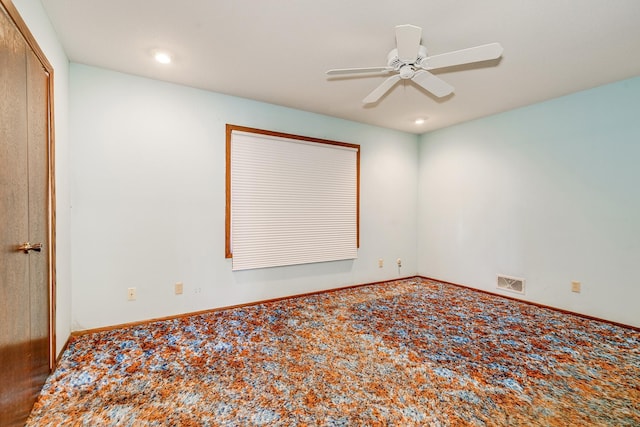 unfurnished room featuring ceiling fan and carpet floors