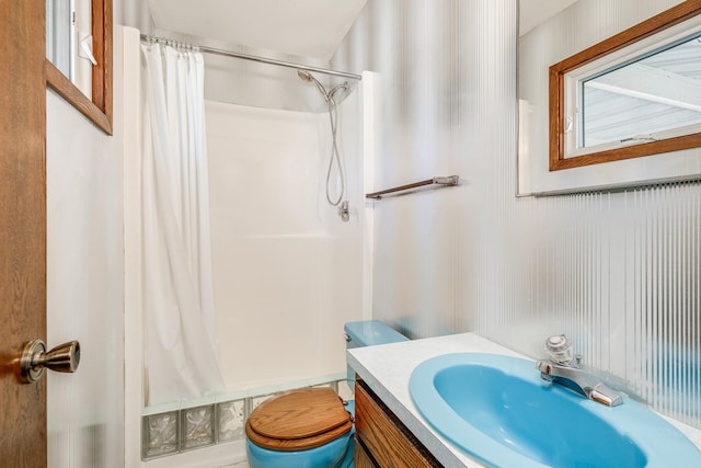 bathroom with vanity, toilet, and a shower with shower curtain