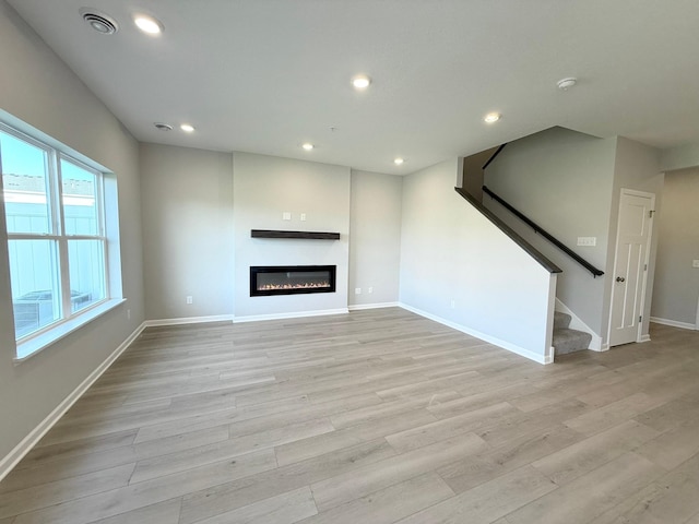 unfurnished living room featuring light hardwood / wood-style flooring