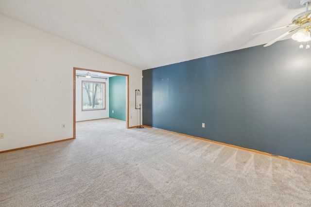 carpeted empty room featuring lofted ceiling and ceiling fan