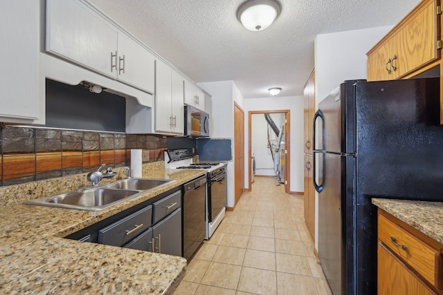 kitchen with backsplash, black appliances, light stone countertops, sink, and light tile patterned flooring