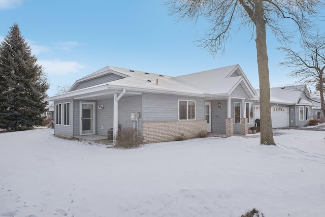 view of front of house with a garage and central AC unit