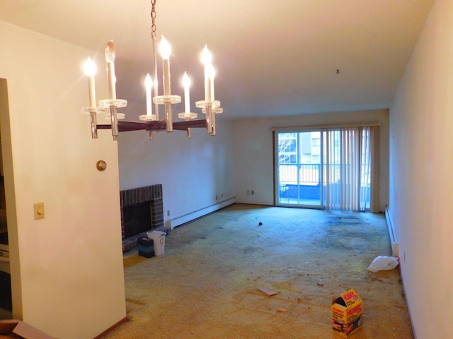 unfurnished living room with a brick fireplace, a notable chandelier, carpet, and a baseboard radiator