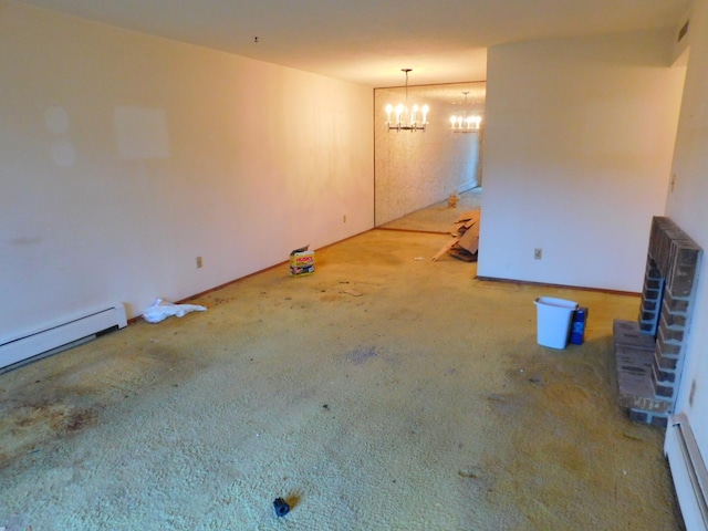 spare room featuring baseboard heating and an inviting chandelier