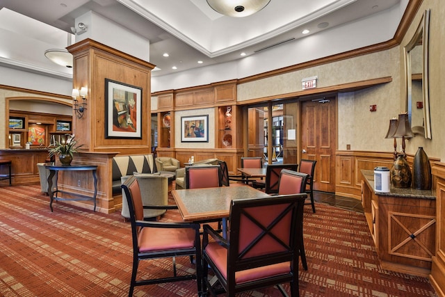 carpeted dining area featuring a towering ceiling