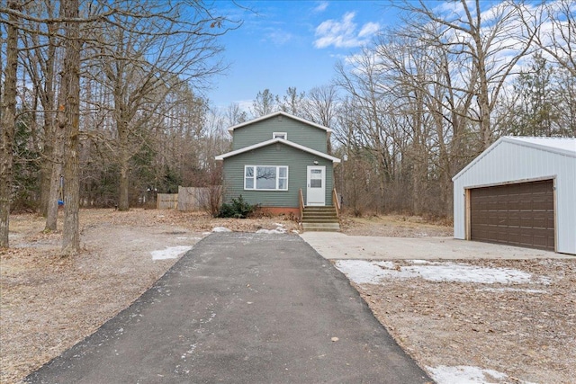 view of front of house with a garage and an outdoor structure