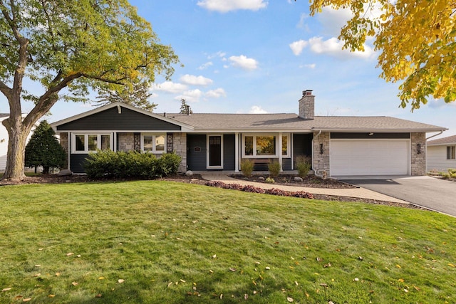 single story home with a garage and a front lawn