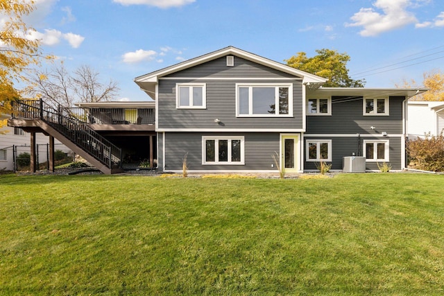 back of property with central AC, a lawn, and a wooden deck