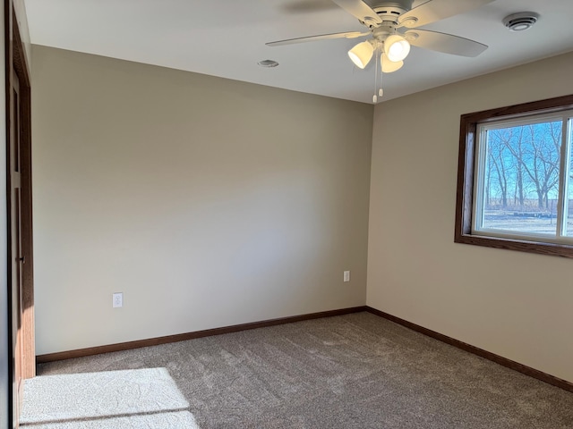 spare room featuring carpet floors and ceiling fan