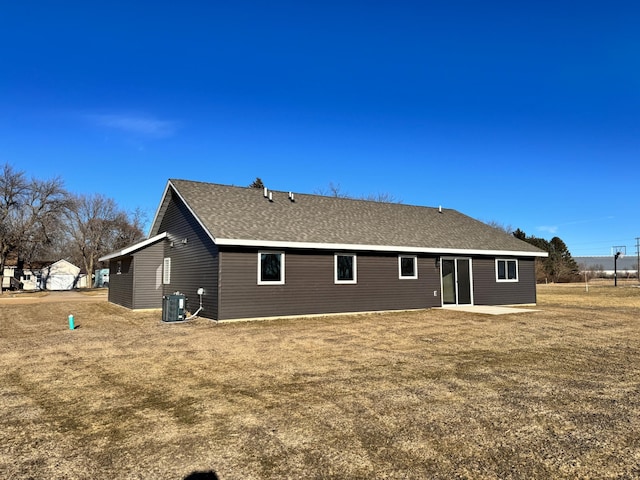 rear view of property with a yard, a patio area, and cooling unit