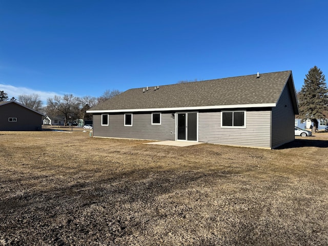 back of property featuring a lawn and a patio