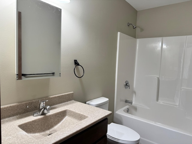 full bathroom featuring washtub / shower combination, vanity, and toilet