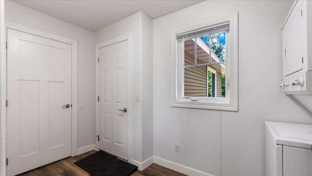 interior space featuring stacked washer and dryer and dark hardwood / wood-style floors