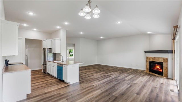 kitchen featuring white cabinetry, sink, hanging light fixtures, and appliances with stainless steel finishes