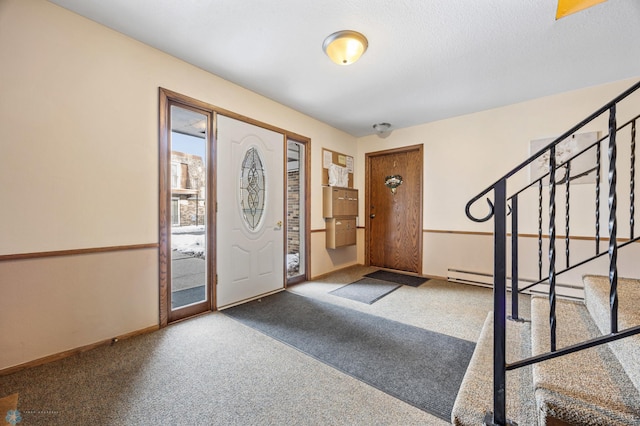 entrance foyer featuring carpet floors and a baseboard heating unit