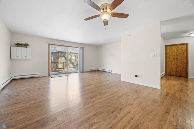 unfurnished living room featuring baseboard heating, ceiling fan, and light wood-type flooring