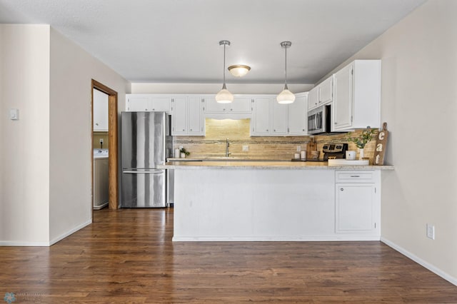 kitchen featuring kitchen peninsula, white cabinetry, stainless steel appliances, and decorative backsplash