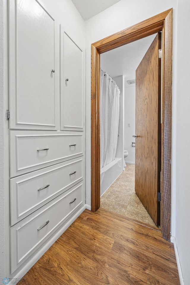 hallway with light hardwood / wood-style flooring