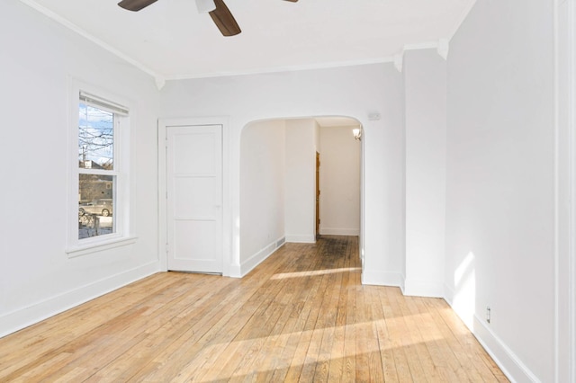 spare room featuring hardwood / wood-style floors, ceiling fan, and a healthy amount of sunlight