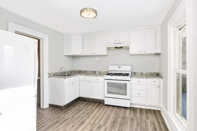 kitchen with light stone countertops, sink, wood-type flooring, white appliances, and white cabinets