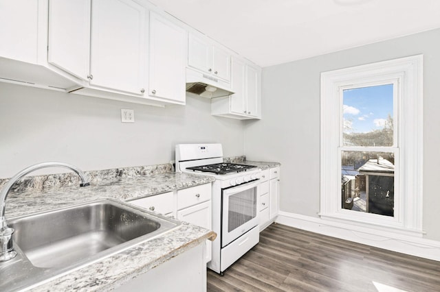 kitchen featuring white range with gas cooktop, sink, white cabinets, and dark hardwood / wood-style floors