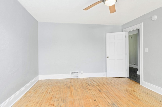 spare room featuring hardwood / wood-style floors and ceiling fan