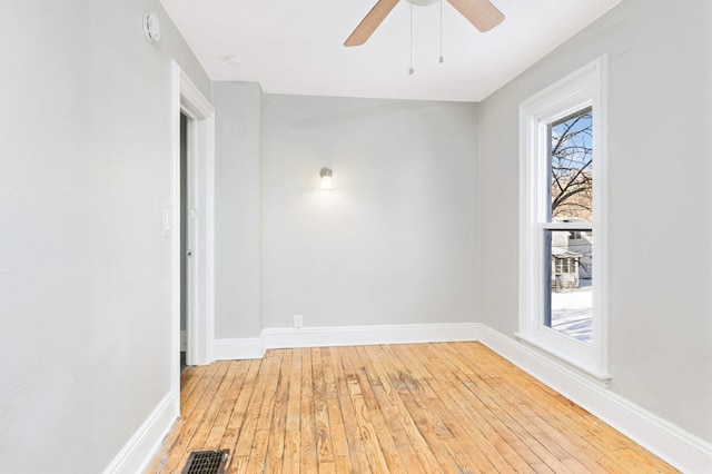 spare room with hardwood / wood-style floors and ceiling fan