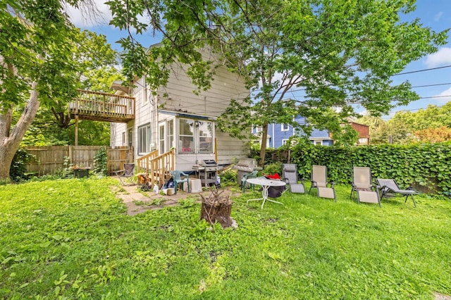 view of yard with a sunroom and a deck