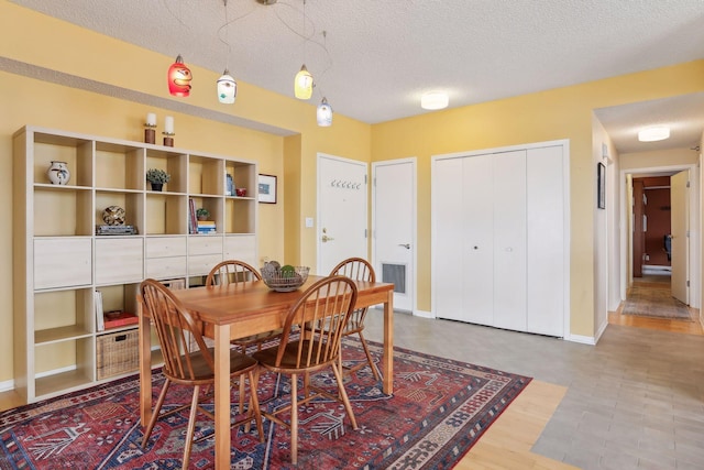 dining space with a textured ceiling