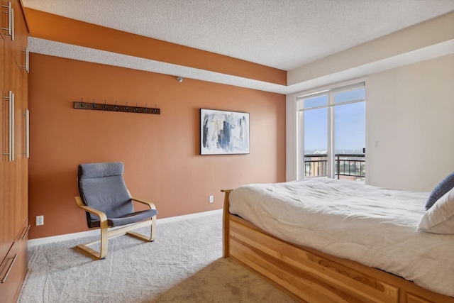 bedroom with access to outside, light carpet, and a textured ceiling