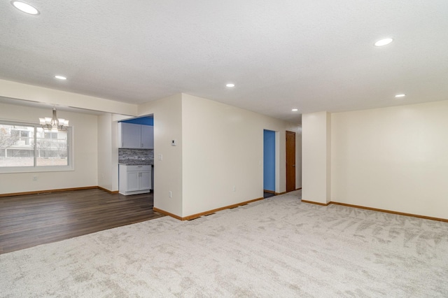 interior space with dark colored carpet and an inviting chandelier