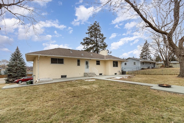 back of property with a lawn and central AC unit