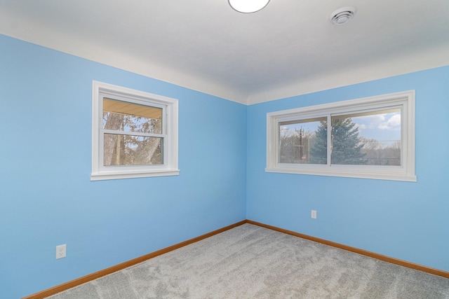 empty room featuring light carpet and a wealth of natural light