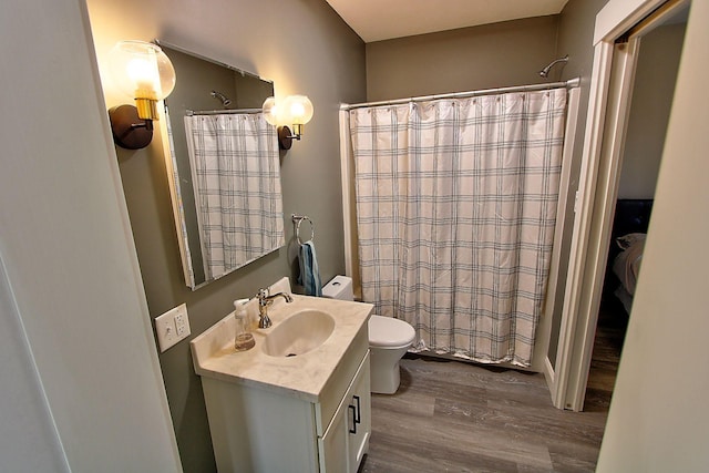 bathroom with a shower with curtain, vanity, hardwood / wood-style flooring, and toilet