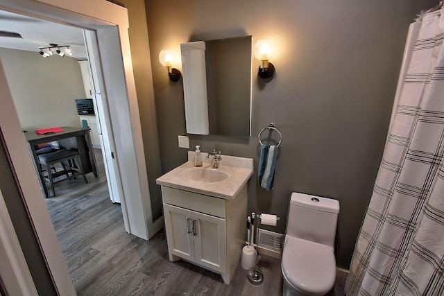 bathroom featuring hardwood / wood-style floors, vanity, and toilet