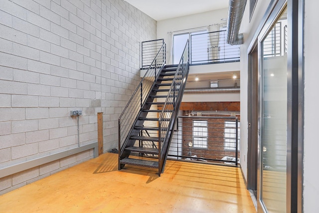 stairs featuring concrete flooring