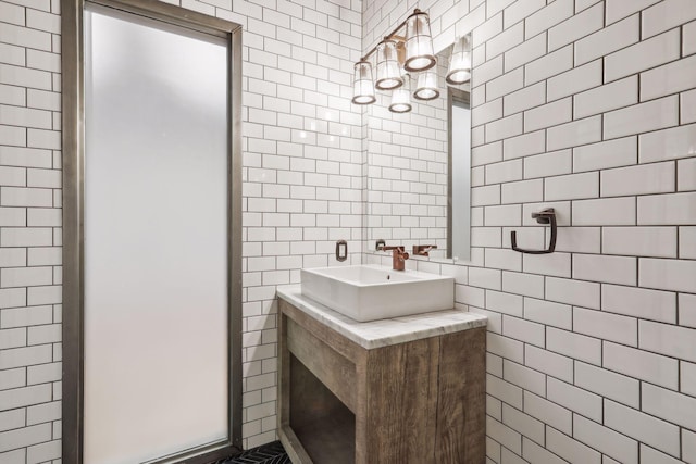 bathroom with vanity and tile walls