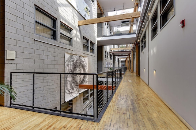 hallway featuring a high ceiling and hardwood / wood-style flooring